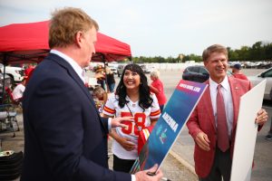 NFL Commissioner Rodger Goodell, left, and Kansas City Chiefs CEO Clark Hunt let Amy Patel, MD, know that she's the Chiefs Fan of the Year.